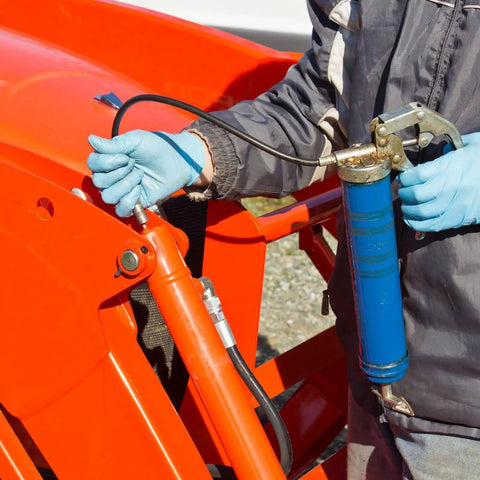 Person using grease gun with Brass Straight Grease Fittings Set for 5/16-24 Thread, 10mm Wide Hydraulic Fittings on machinery