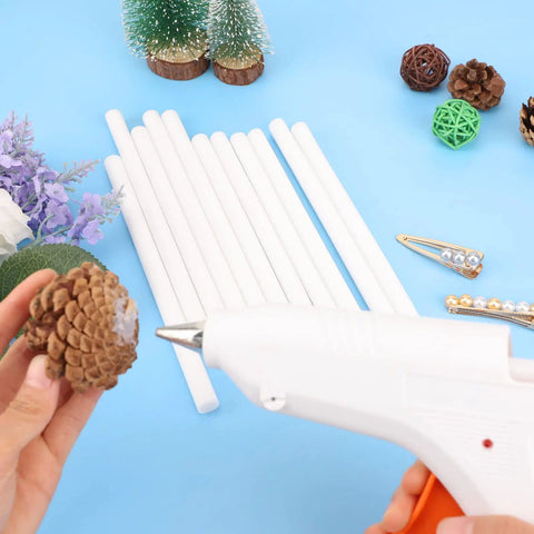 White Hot Glue Sticks Bulk Pack With 36 Full Size Eight Inch Sticks For DIY Crafts Art Projects School Projects Repair And Sealing Ideal For Quick Bonds And Strong Holds shown with glue gun and pinecone.