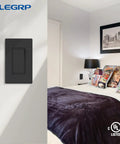 Matte Black 3 Way Decorative Light Switch With Wall Plate, 15 Amp, 120-277 Volt AC Rocker Paddle in a bedroom setting