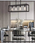 Black Four Light Kitchen Island Pendant Chandelier Fixture installed above dining table in modern kitchen