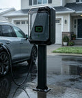 Weatherproof EV Charger Box With Double Lock Guard For Outdoor Use, mounted on a pedestal in rain beside a vehicle.