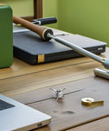 Close-up of a Stainless Steel Archery Arrowheads Set 8 Piece Judo Broadheads for Hunting and Small Game on a wooden desk.