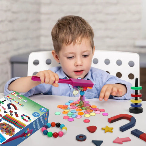 Child playing with 228 Piece Magnetic Science Kit For Kids With Magnetic Balls Chips And Wands 7 Shaped Magnets And Post With Rings