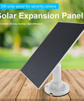5W Outdoor Solar Panel For Wireless Security Cameras With USB C And Micro USB Compatibility, mounted on wooden surface