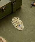 Premium Golden Duckbill Hasp Latches For Wood Boxes And Tool Cases Secure Tiny Jewelry Trays With Durable Toggle Hook Hardware on green surface.