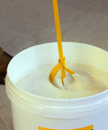Beefy Paint And Mud Mixer Stirrer For Drill, 1 To 5 Gallon Drums, Fits All Standard Drill Bits, Hex Head Non Slip, Easy To Clean Paint And Plaster Mixing Paddle Tool Yellow mixing white paint in a 5-gallon bucket