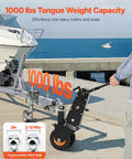 Heavy Duty Trailer Dolly With 1000 Lb Tongue Weight Support swappable hitch balls on pneumatic tires near boat ramp.