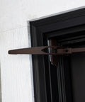 Heavy Duty Adjustable Front Door Garland Hanger with Padded Ends providing solid grip on door jambs, mounted at 51 inches.