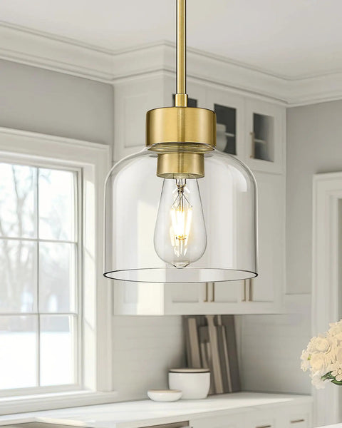 2 Pack 7 Inch Brushed Gold Pendant Lights With Crystal Clear Glass Shades For Kitchen Island And Dining Room hanging above a counter.