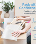 Person placing frame in box with 200 Pcs Moving Pro Grade Cushioning Foam Pouches And Sheets 11.8 By 9.8 Inches White Foam Pouch