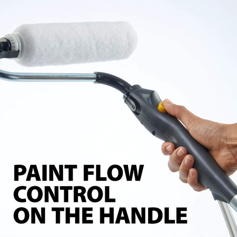 Hand holding Smart Sidekick Workhorse Power Paint Roller Direct Feed System with paint flow control button and roller head visible.