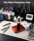 Slick Mini Bench Vise Featuring Sweet 360 Degree Rotating Ball Joint Base, Legit Aluminum Alloy Table Top Hobby Clamp Offering Flexible Multi Angle Tilting And Secure Grip For Gunpla Assembly Jewelry Repair Electronics Soldering Work, Rich Red on a workshop desk.