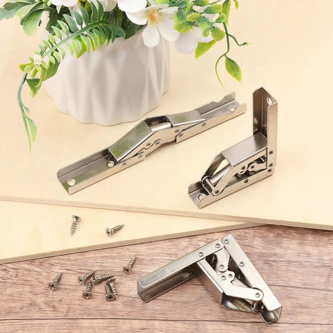 Rock Solid Nickel Plated Hidden Hinges For Cabinet Doors And Shelves Built Tough As Nails With Smooth Swing Operation Easy No Drill Install Heavy Duty Furniture Hardware 10 Pack displayed with screws and a plant.