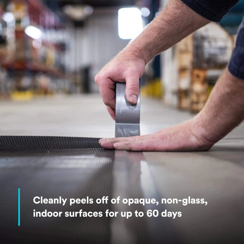 Person applying Extra Heavy Duty Duct Tape 6969, Silver, Industrial Strength on warehouse floor.