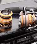 Real Smooth Spinning Fishing Reel Size 200 Decked Out With 10 Plus 1 Bearings And 6.2 To 1 Gear Ratio on a dark tabletop.