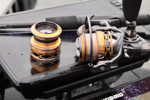 Real Smooth Spinning Fishing Reel Size 200 Decked Out With 10 Plus 1 Bearings And 6.2 To 1 Gear Ratio on a dark tabletop.