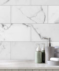 Marble backsplash with bathroom accessories. Slick Cool Gray Polished Quarter Round Tile Trim 1/2 Inch X 12 Inch Edge Cap shown.