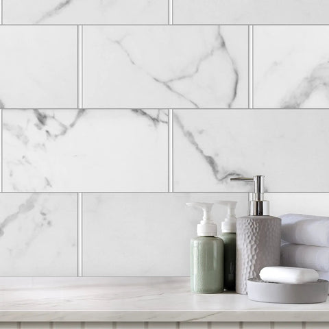 Marble backsplash with bathroom accessories. Slick Cool Gray Polished Quarter Round Tile Trim 1/2 Inch X 12 Inch Edge Cap shown.
