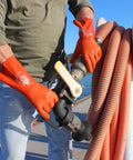 Person wearing Double Dipped PVC Chemical Resistant Gloves With Rugged Grip And Seamless Cotton Liner 12 Inch Length Latex Free Orange Small Size 12 Pack Built For Rough And Tough Jobs, handling industrial hose.