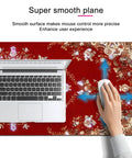 Massive 31.5 By 11.8 Inch Gaming Mouse Pad With Luxury Red Ornamental Pattern shown with laptop and hand using mouse