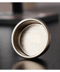 Premium Titanium Portafilter Basket 58.5mm Holds 18 To 20 Grams showing fine perforations for optimal espresso extraction.