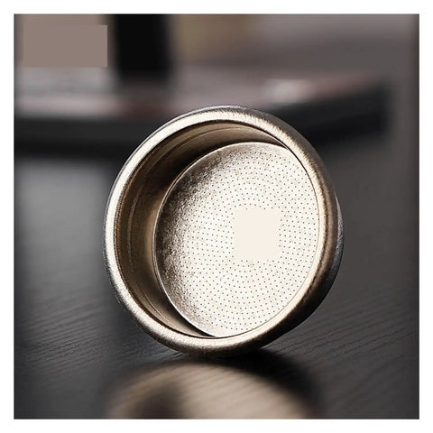 Premium Titanium Portafilter Basket 58.5mm Holds 18 To 20 Grams showing fine perforations for optimal espresso extraction.