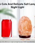 Himalayan Salt Lamp Night Light With Remote Control 5.5 Inch pink rock on wood base next to soda can