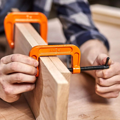 Person using 2-1/2 Inch C Clamp Heavy Duty For Woodworking And DIY Projects, 600 Pound Load Capacity, 2 Inch Opening, 1-3/8 Inch Throat.