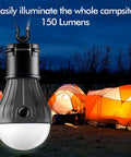 Palm Sized Portable LED Tent Light With Hanging Hook Emergency Lantern For Camping Hiking Backpacking Fishing And Power Outages Multicolor Glow 4 Pack Runs On 3 AAA Batteries Not Included hanging in front of illuminated tents at night.