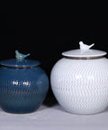 Keep Your Staples Fresh With This Heavy Duty Ceramic Rice Bucket Dispensing Grains Coffee Beans And Tea While Keeping It Tight In Your Pantry Where The Blue And White Glaze Makes Your Kitchen Setup Look Slick And Sharp. Two ceramic jars, blue and white, with bird tops for storage.