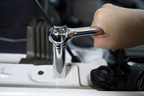 Close-up of Heavy Duty Socket Wrench Set With One Half Inch And Three Eighth Inch Drive Ratchets in use on car engine