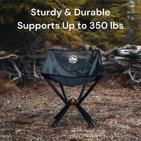 Ultra Compact Portable Camp Chair That Folds To Bottle Size Ready In Seconds A Real Game Changer For Camping And Outdoors Supports Up To 350 Lbs Lightweight And Built For Hiking Adventures Black on rocky terrain.