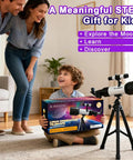 Child holding a box of Totally Kid Friendly 60mm Telescope With 18x To 90x Magnification next to tripod in a living room.