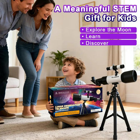 Child holding a box of Totally Kid Friendly 60mm Telescope With 18x To 90x Magnification next to tripod in a living room.