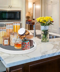 Set Of Two 12 Inch Non Skid Lazy Susan Organizer Smooth Spinning Turntable For Pantry Cabinet Kitchen Storage Game Changer With Super Grippy Rubber Base And Ball Bearings with jars on marble countertop.