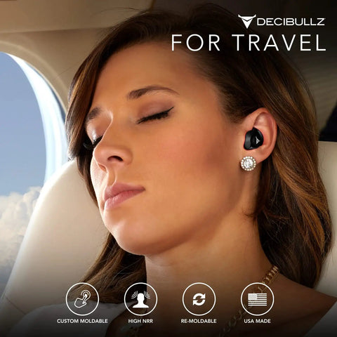 Woman wearing Custom Molded Reusable Earplugs For Noise Reduction 25 Decibel Level Block Out The City Chaos And Fly In Comfort