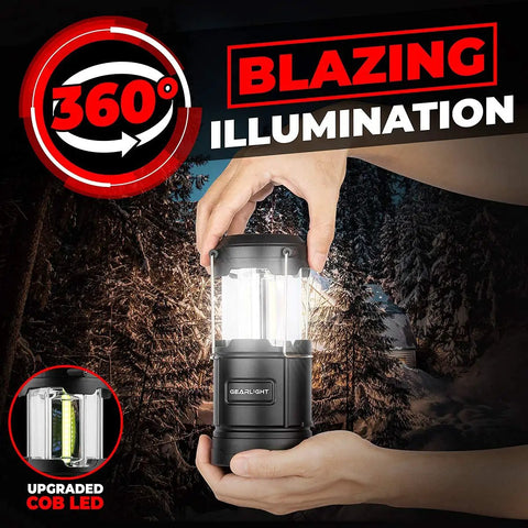 Person holding Portable LED Camping Lantern With Battery Power in black, showcasing 360° blazing illumination in a snowy forest.