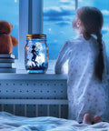 12 Pack Solar Mason Jar Fairy Lights With 30 Warm White LEDs on a windowsill with a child gazing outside