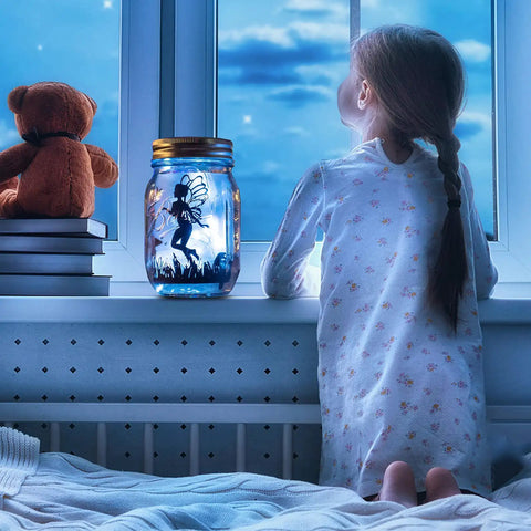 12 Pack Solar Mason Jar Fairy Lights With 30 Warm White LEDs on a windowsill with a child gazing outside