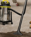 Heavy Duty Wet And Dry Vacuum Cleaner With 4 Gallon Tank And 4 HP Power, Stainless Steel Canister in use in a workshop