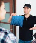 Person holding Blue Aluminum Film Bubble Mailers 50 Count, Built Tough Padded Envelopes With Self Sealing, Lightweight Shipping Mailers