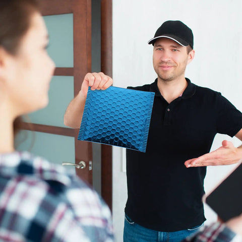 Person holding Blue Aluminum Film Bubble Mailers 50 Count, Built Tough Padded Envelopes With Self Sealing, Lightweight Shipping Mailers