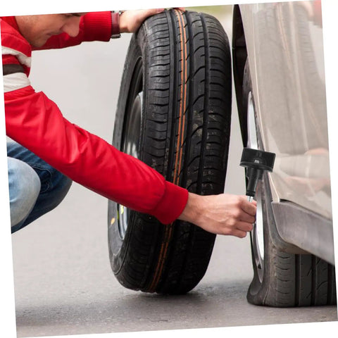 Person using Replacement Spare Tire Hold Down Bolt For Pickup Trucks on a flat tire, showing installation process.