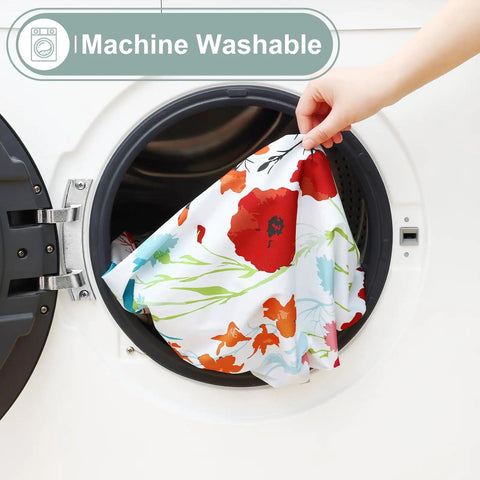 Hand placing flower print All-in-One Picnic Table Cover Set With Bench Covers For 6 Foot Tables into a washing machine.