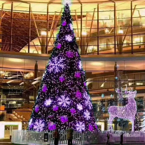 Purple 66 Foot 200 LED String Lights With 8 Modes on outdoor Christmas tree in front of a glass building at night