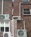 External view of Line Set Cover Kit 3-Inch For Mini Split And Central Air Conditioning And Heat Pumps, 7 Feet installed on brick walls.