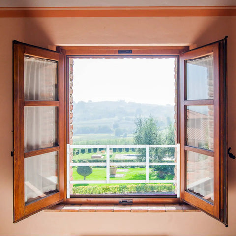 Beefy Kid Proof Window Guard Fixed Child Safety Barrier With No Sweat Setup And Tight Bar Spacing Non Egress Design Keeps Little Ones Secure Smooth White Finish With Strong Mounting Kit, installed on wooden window frame.