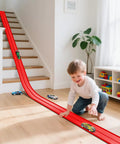 Child playing with Flexible Roll Up Two Lane Race Track For Kid Friendly Play With Suction Cups Includes Four Mini Diecast Cars 1 64th Scale