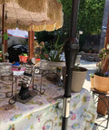Heavy Duty Umbrella Clamp Holder For Patios And Beach Tents Adjustable Outdoor Shade Mount secured on a picnic table.