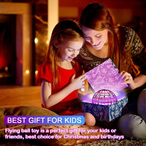 Mother and daughter opening a gift box with a glowing 2025 Upgraded Flying Orb Ball Toy With Hover Boomerang Spin Mini Drone inside.